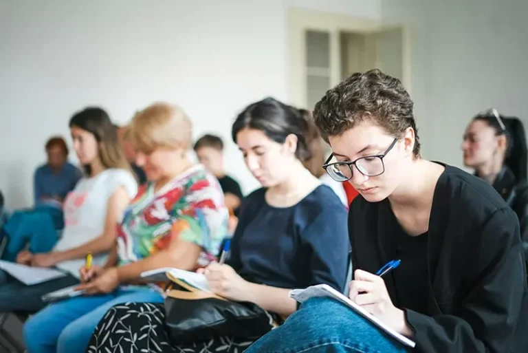 Audience taking notes at a seminar
